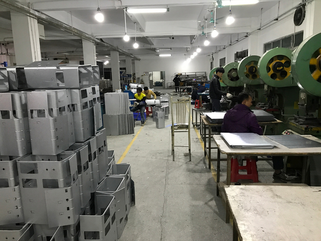 Sauna heater assembly production line with industrial workspace